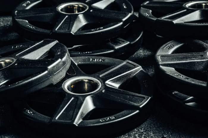 Close-up of weight plates racked at a Fitbox International training session
